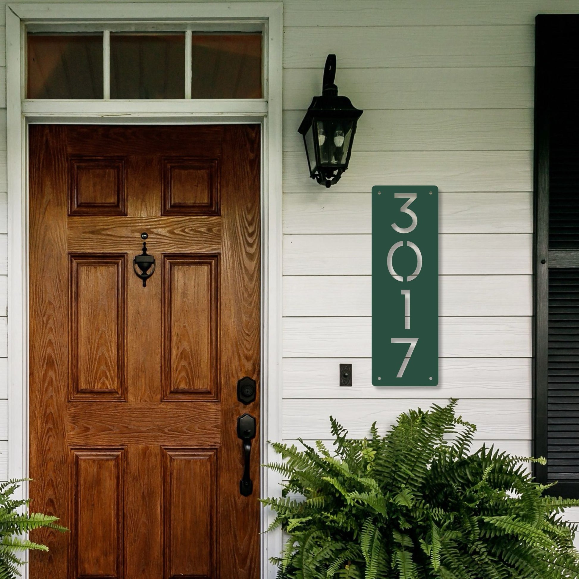 Wooden front door with house number '3017' on a white wall.