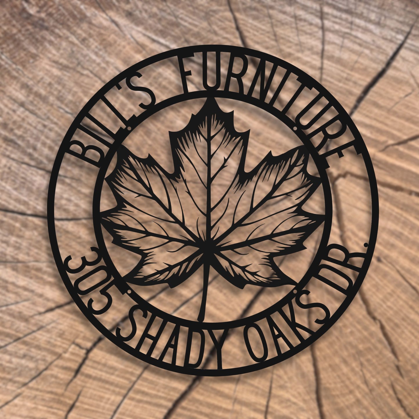 Decorative metal sign with a maple leaf and text on a wooden background