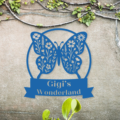 Blue butterfly design with 'Gigi's Wonderland' text on a stone background