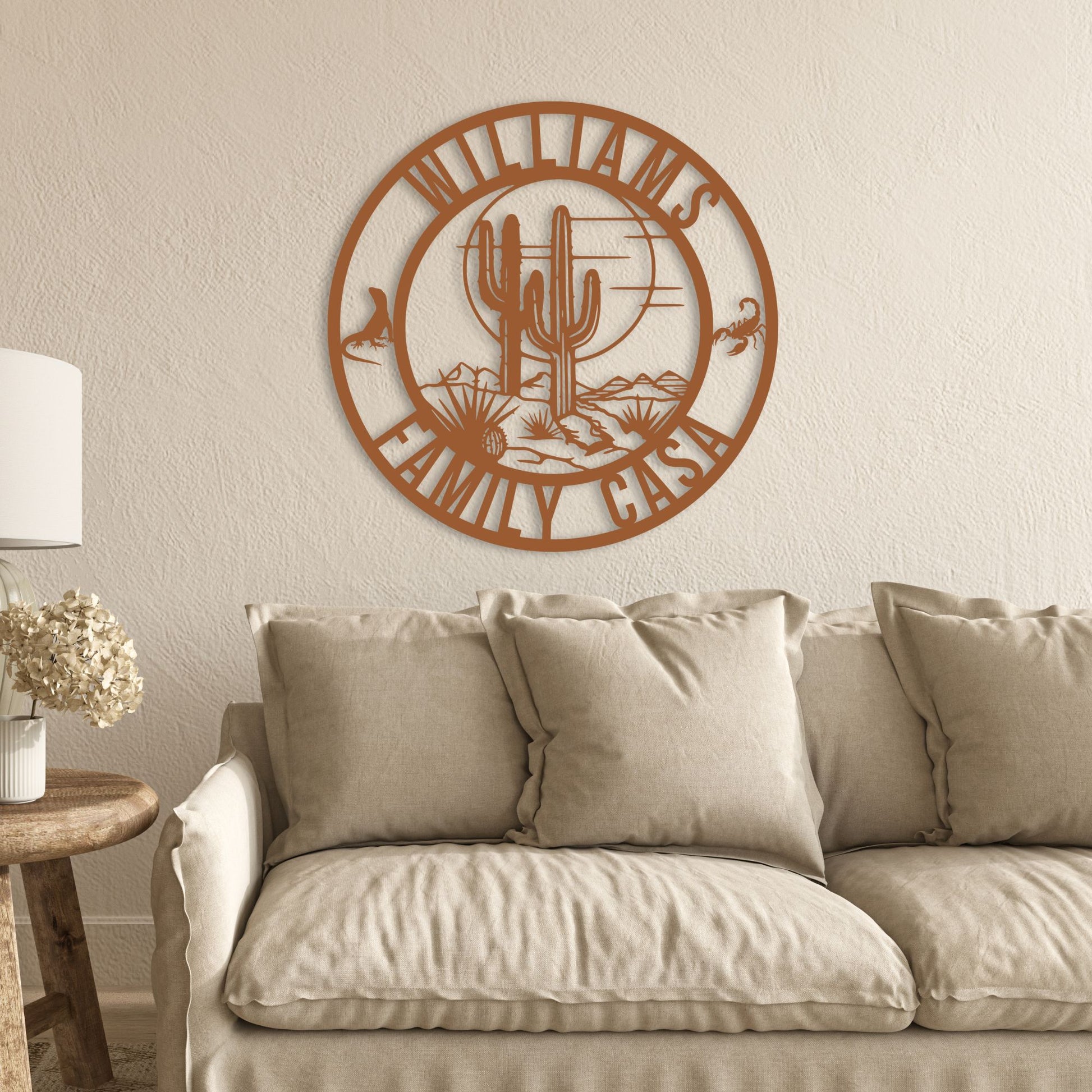 Decorative wall art with 'Williams Family Casa' on a beige wall above a beige sofa.