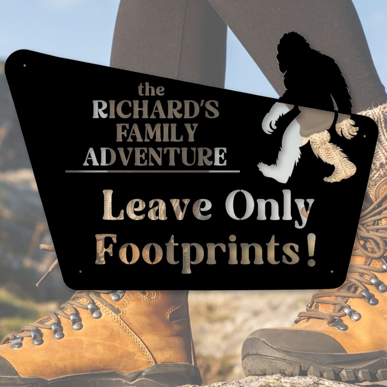 Hiking boots with a sign reading 'the RICHARD'S FAMILY ADVENTURE Leave Only Footprints!' against a natural background.