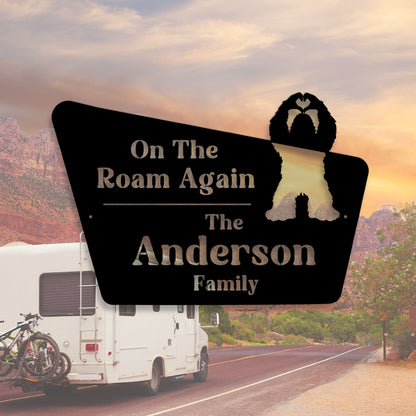 Personalized sign for an RV with 'On The Roam Again' and 'The Anderson Family' text, set against a scenic road backdrop.