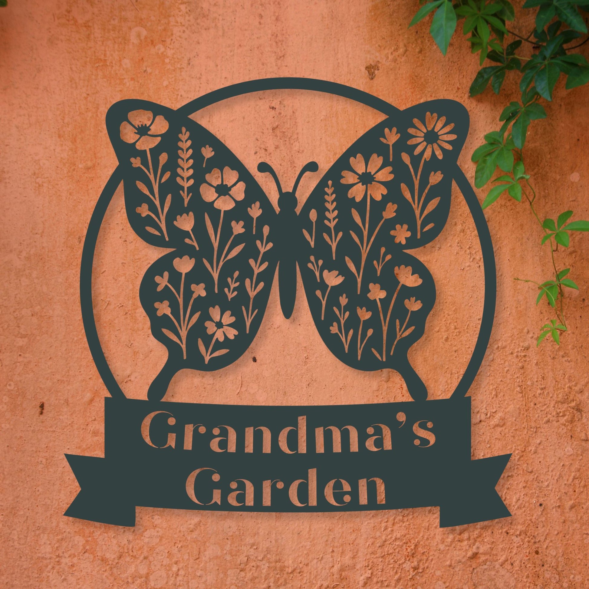Butterfly-shaped sign with floral details and 'Grandma's Garden' text on a textured surface.