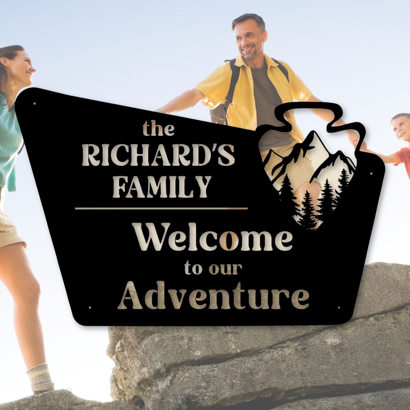 Family hiking with a personalized adventure sign in the foreground