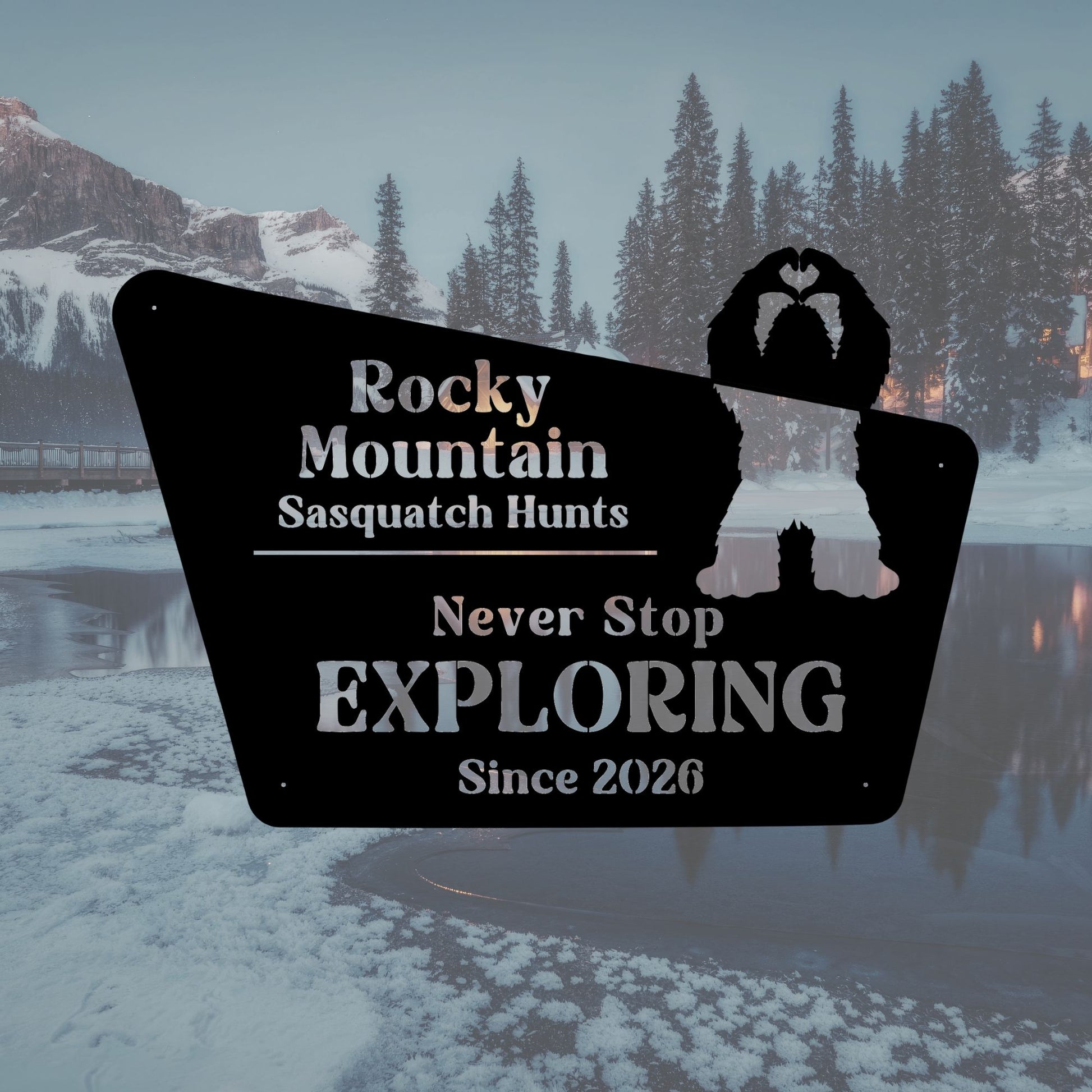 Promotional sign for Rocky Mountain Sasquatch Hunts with a silhouette of a bear against a snowy mountain backdrop.