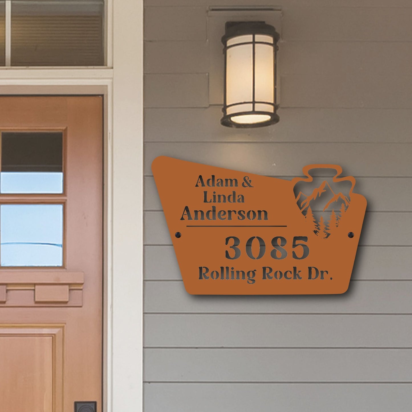 House exterior with a personalized address sign on a gray wall.