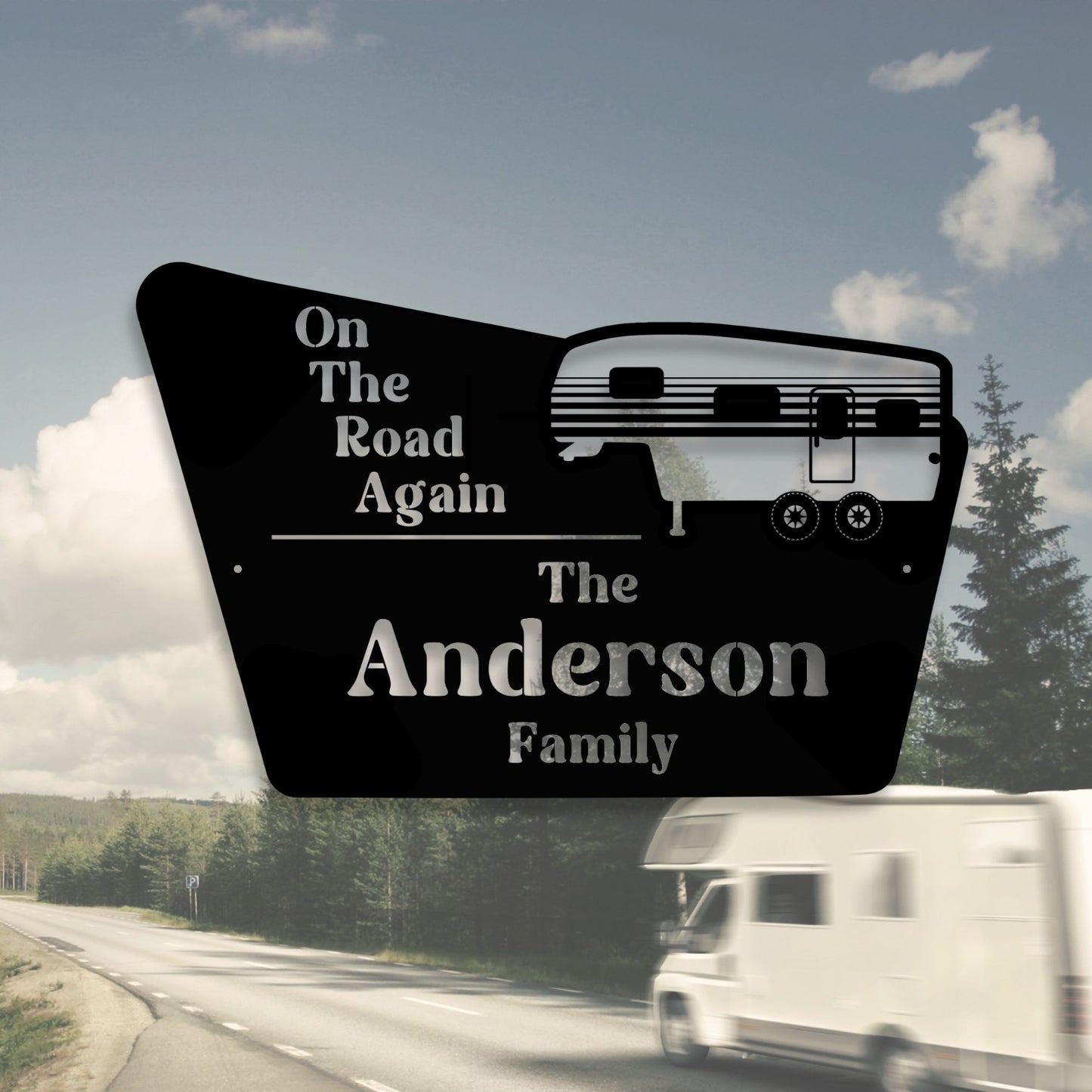 Decorative sign with 'On The Road Again' and 'The Anderson Family' text, with a blurred RV in the background.