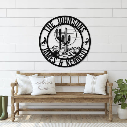 Decorative wall clock with cactus design and 'The Johnsons' text above a wooden bench.