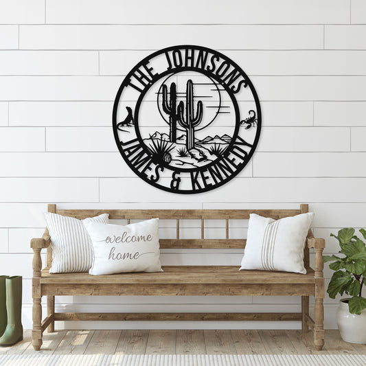 Decorative wall clock with cactus design and 'The Johnsons' text above a wooden bench.