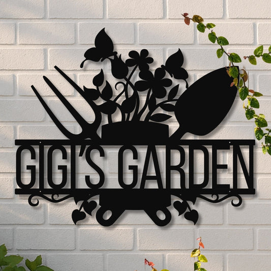 Decorative metal sign with 'GIGI'S GARDEN' on a white brick wall.