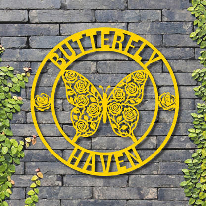 Yellow metal butterfly design with 'Butterfly Haven' text on a stone wall background