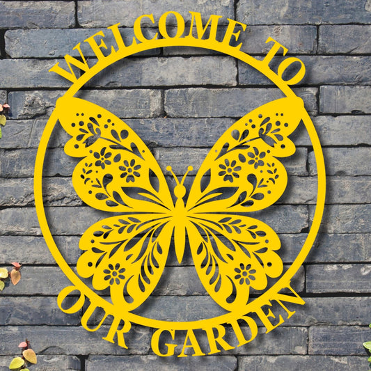 Yellow butterfly-shaped sign with 'Welcome to our Garden' text on a stone wall background.