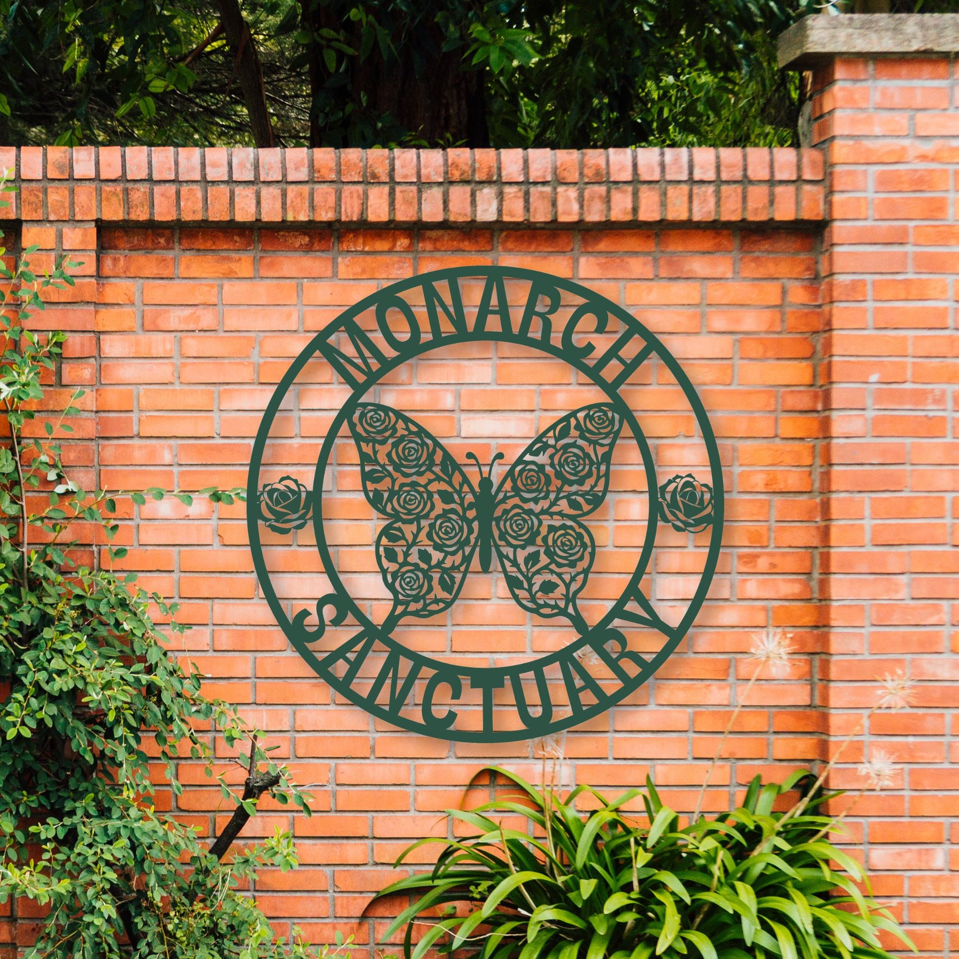 Metal sign with butterfly design on a brick wall, surrounded by greenery