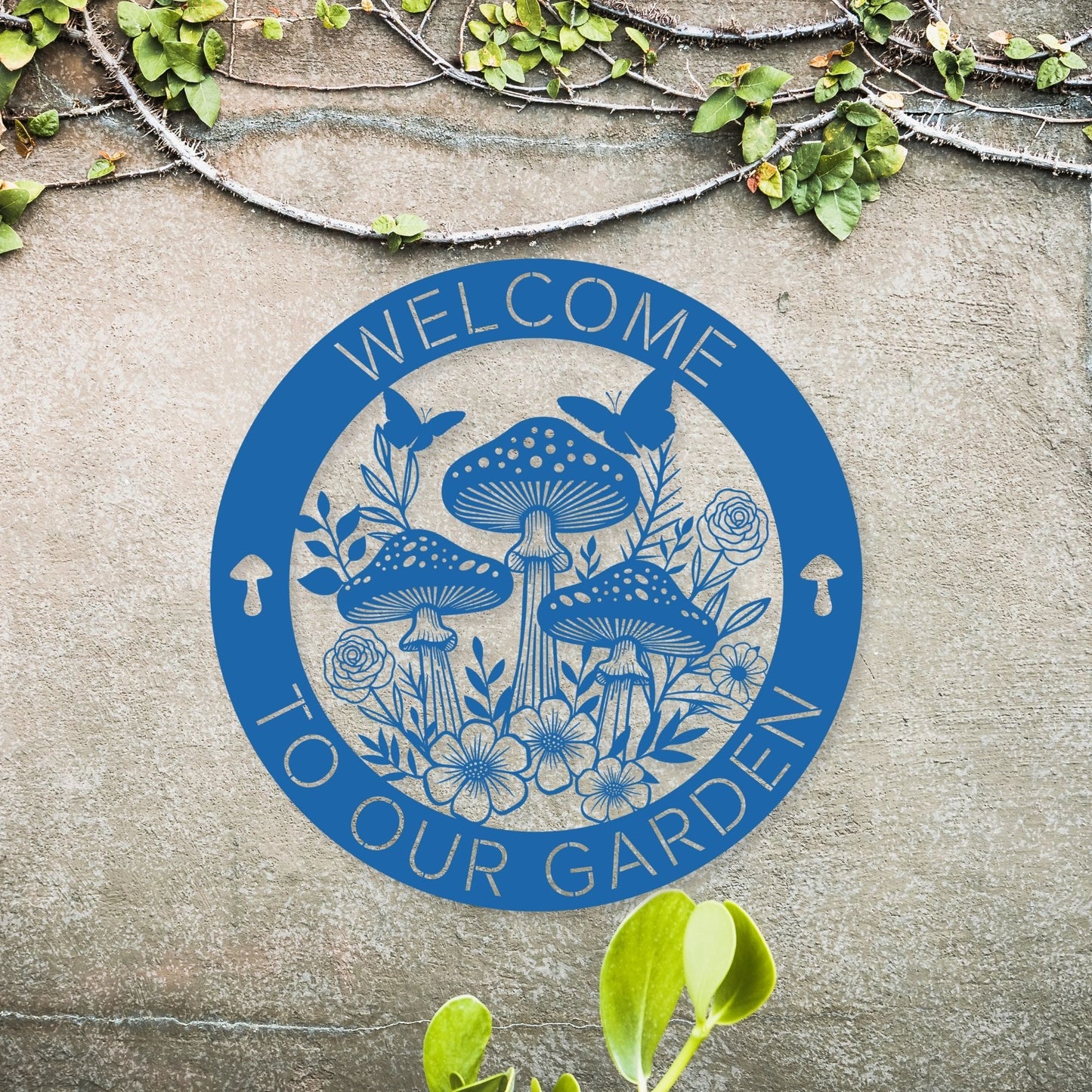 Circular blue logo with mushrooms and flowers on a stone surface, featuring the text 'Welcome to our garden'.