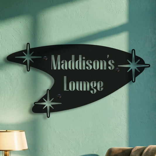 Decorative wall sign with 'Maddison's Lounge' in a cozy room with a chair and lamp.