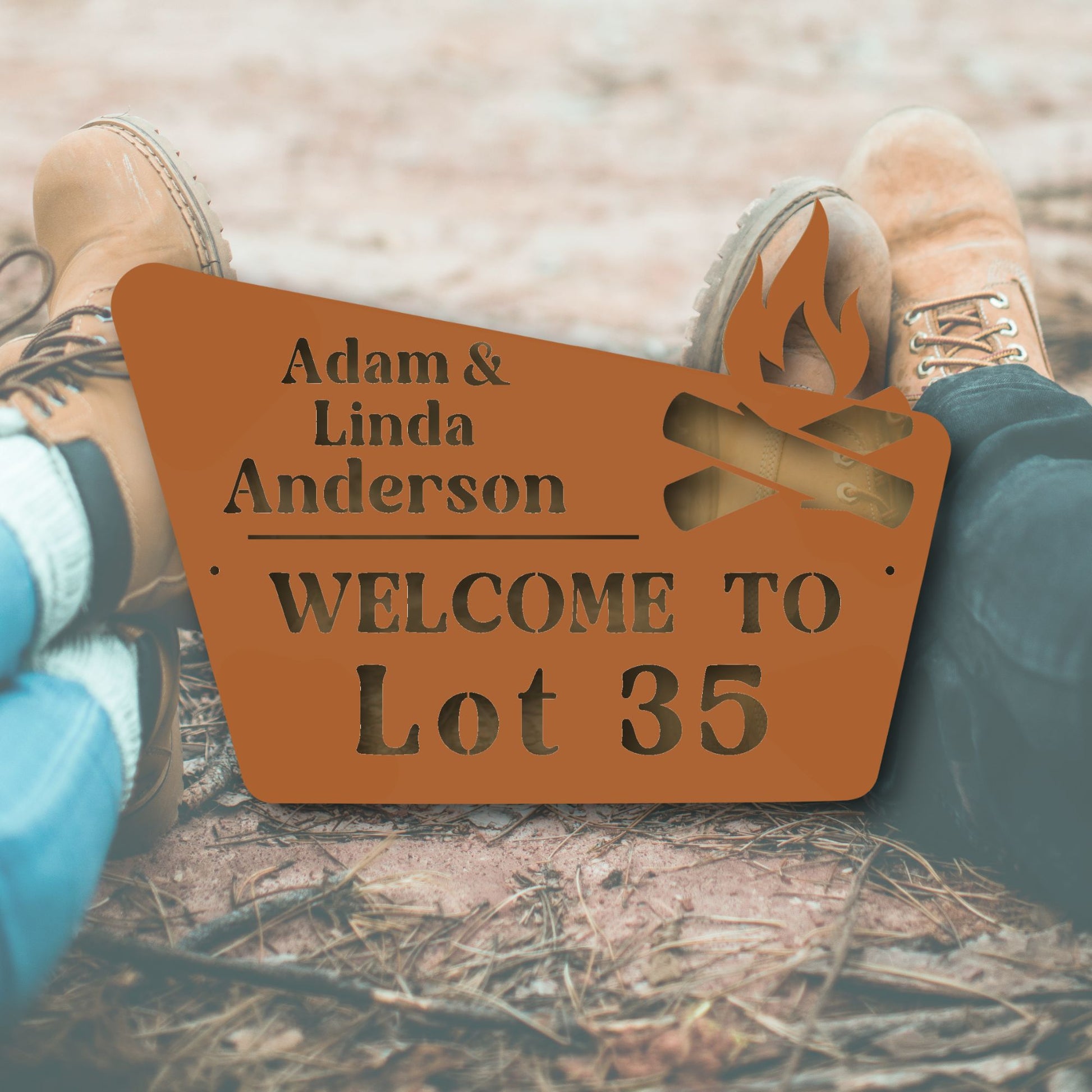 Personalized metal sign with 'Adam & Linda Anderson WELCOME TO Lot 35' text, placed between feet on a natural ground.