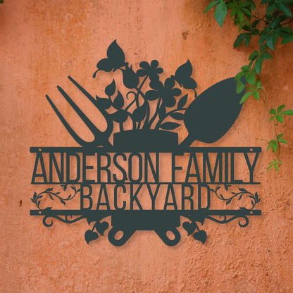 Decorative metal sign with 'Anderson Family Backyard' text on a textured wall.