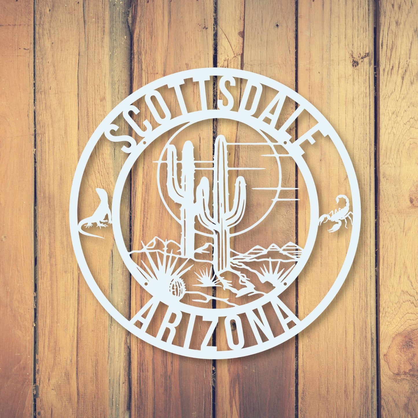 Decorative metal sign with 'Scottsdale, Arizona' on a wooden background