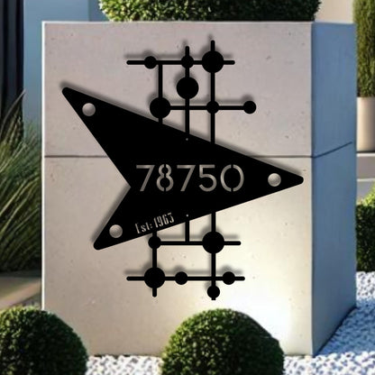 Decorative metal wall art with geometric design and numbers on a light background