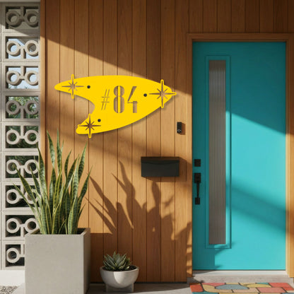 Yellow door hanger with number 84 on a wooden door with a blue side panel.