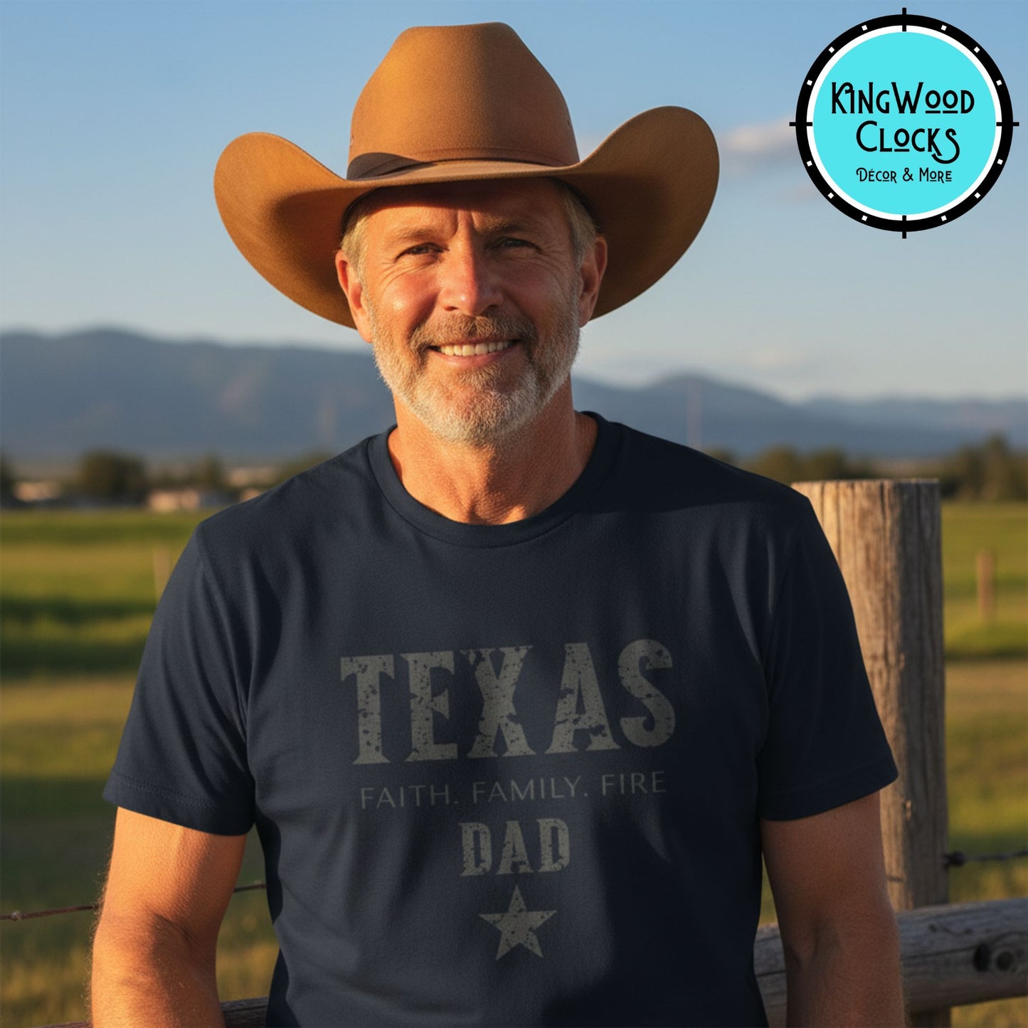Man wearing a cowboy hat and 'Texas Dad' t-shirt in a scenic outdoor setting with Kingwood Clocks logo.