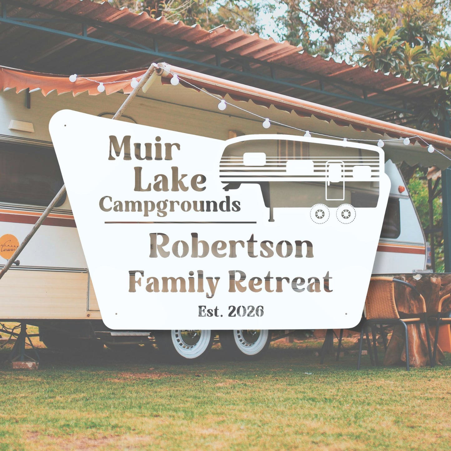 Sign for Muir Lake Campgrounds Robertson Family Retreat with an RV in the background