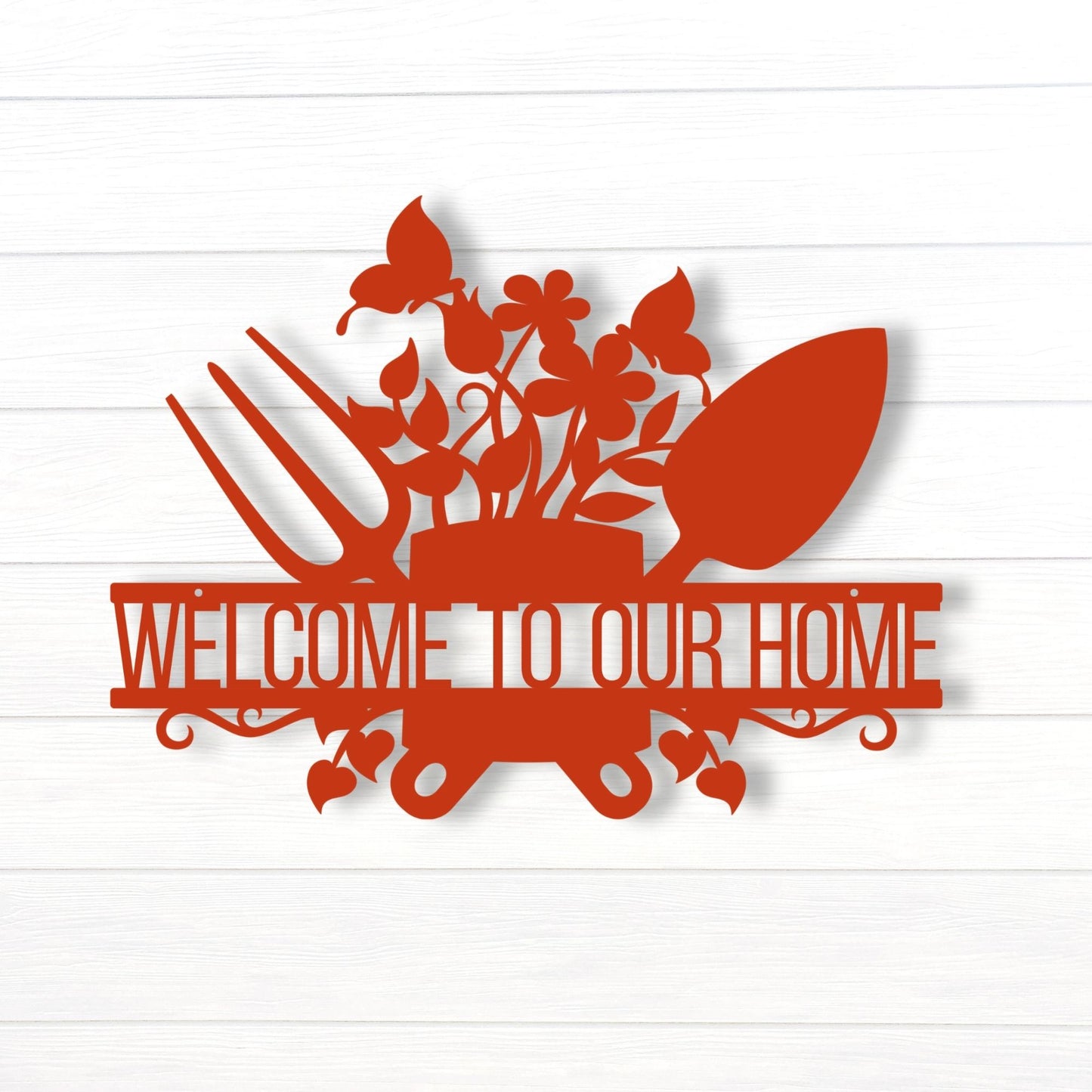 Decorative sign with floral design and 'Welcome to Our Home' text on a white background