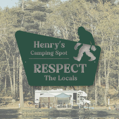 Sign for 'Henry's Camping Spot' with a silhouette of Bigfoot and text 'Respect the Locals' in a forest setting.