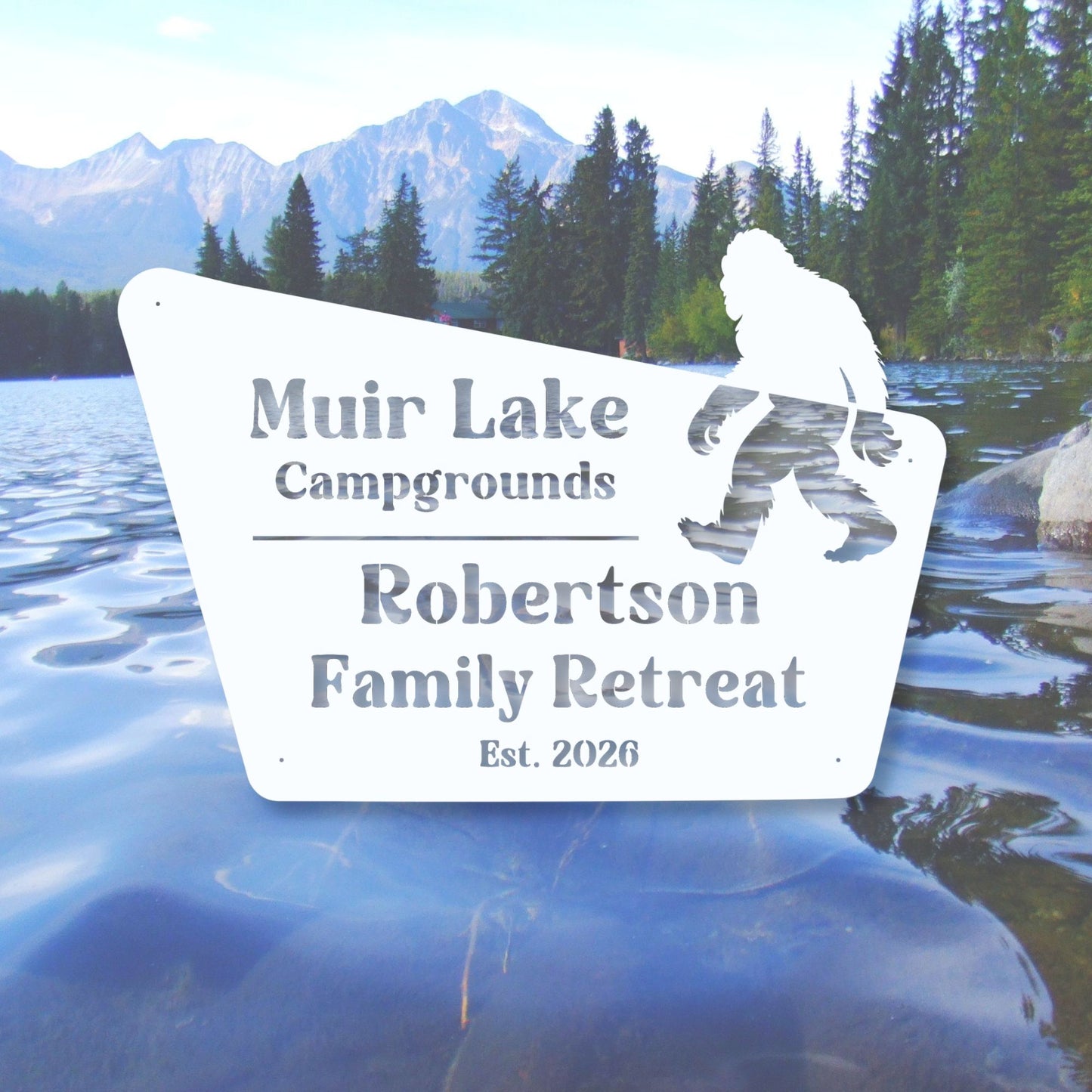 Sign for Muir Lake Campgrounds Robertson Family Retreat with a mountain and lake background