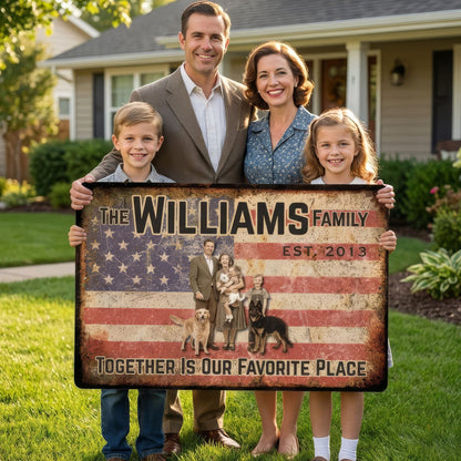 Family holding a sign with 'The Williams Family' and an American flag design in front of a house.