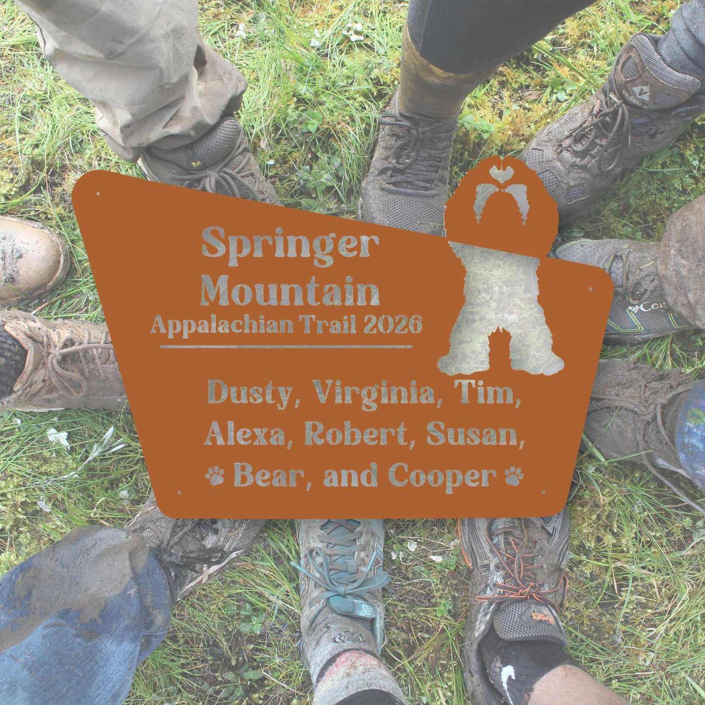 Hiking boots around a sign for Springer Mountain Appalachian Trail 2020 with names listed.