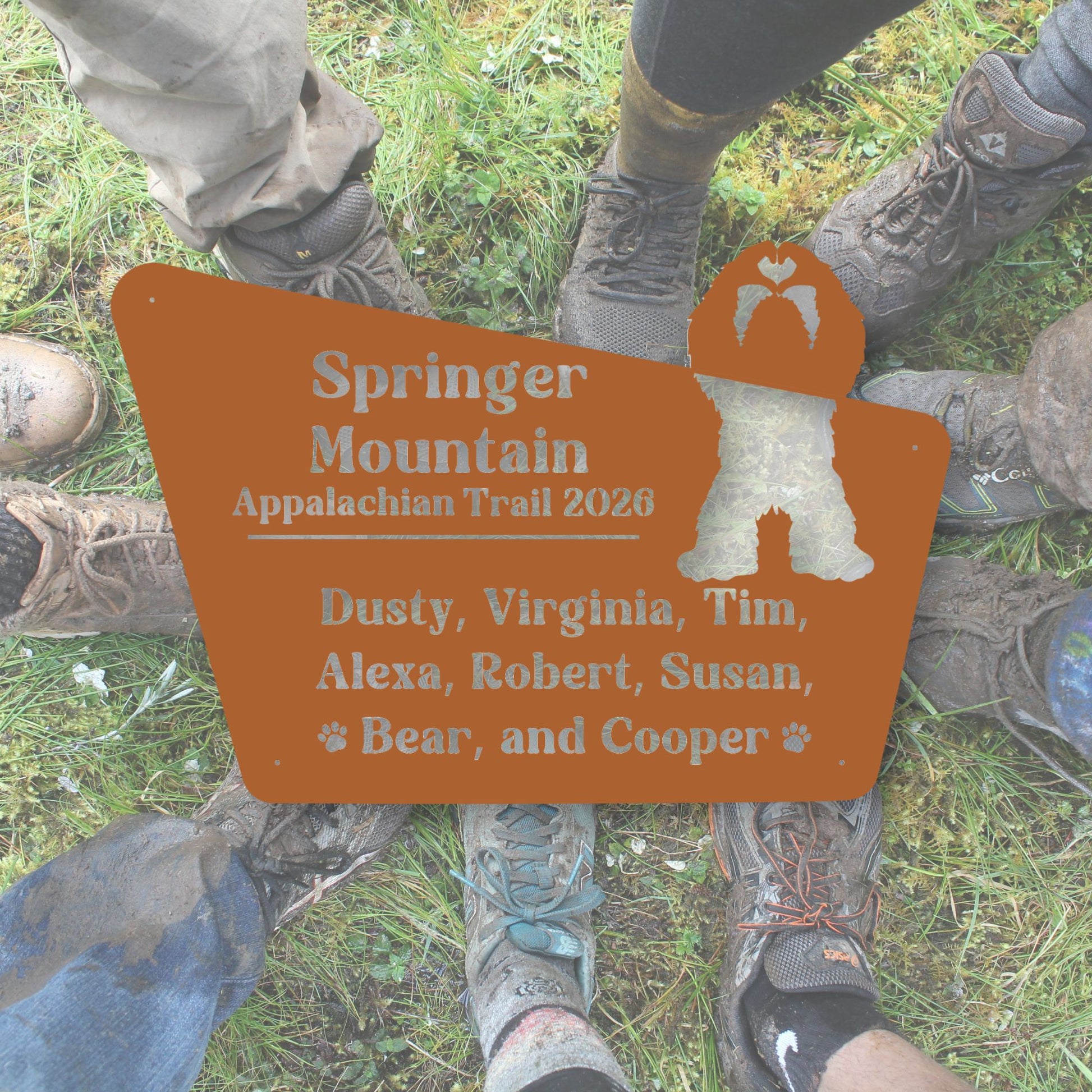 Hiking boots around a sign for Springer Mountain Appalachian Trail 2020 with names listed.