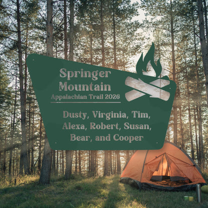 Camping scene with a sign for Springer Mountain Appalachian Trail 2020 and an orange tent in the woods.