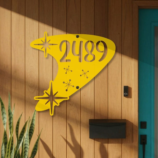 Modern house exterior with a yellow address sign, blue door, and potted plants.
