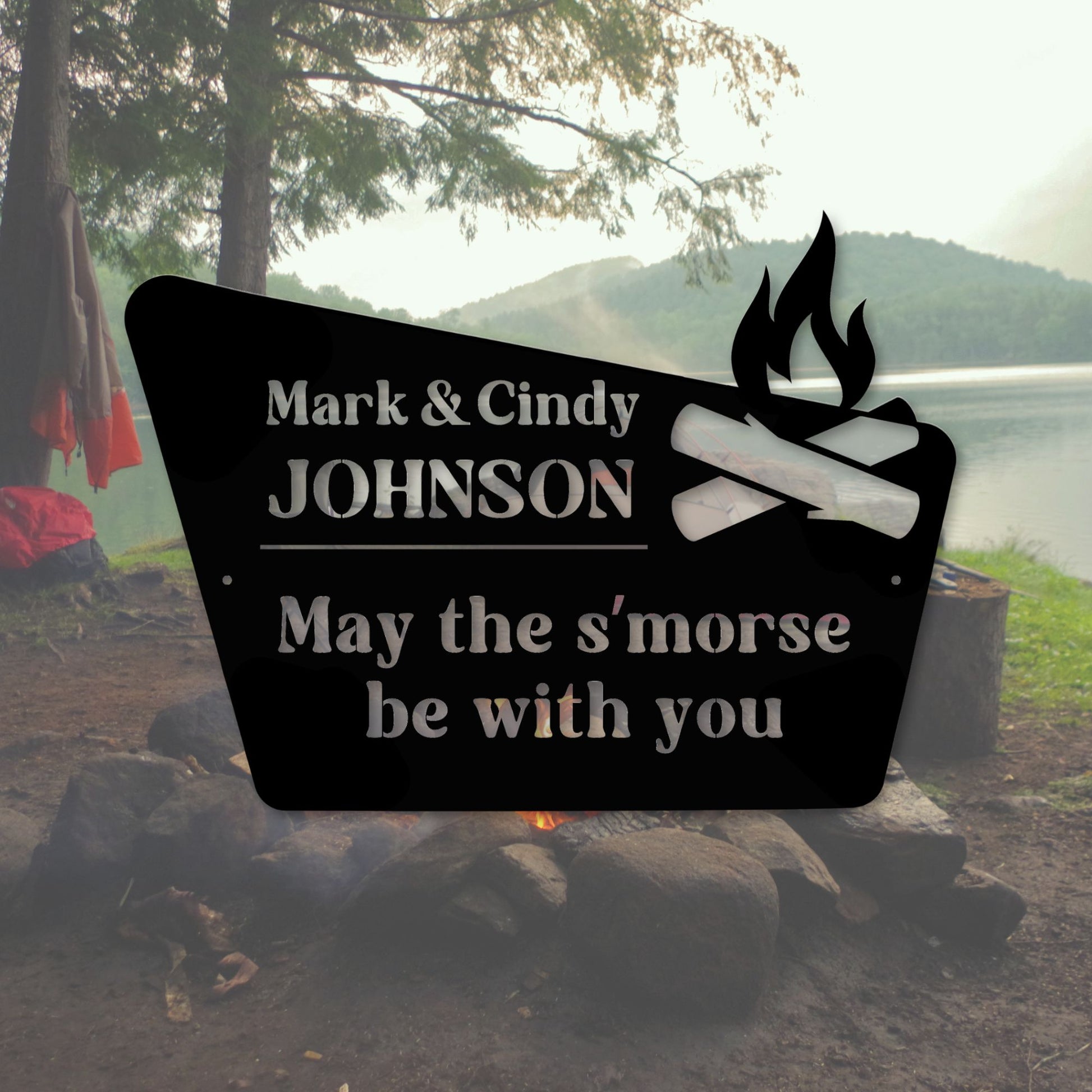 Personalized metal sign with campfire design and text in a camping setting.