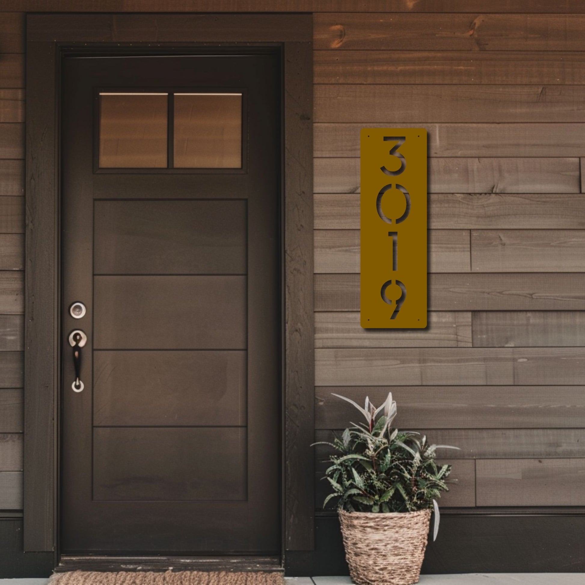 Modern front door with a house number sign on a wooden wall