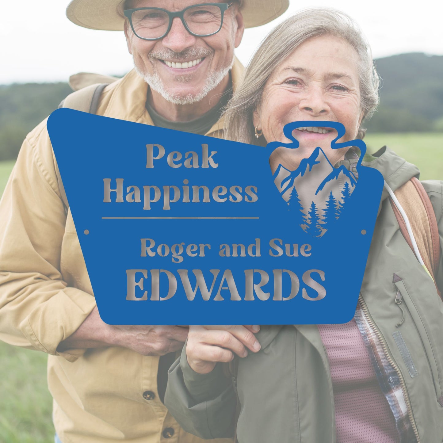 Two people holding a blue sign with 'Peak Happiness' and 'Roger and Sue Edwards' text.