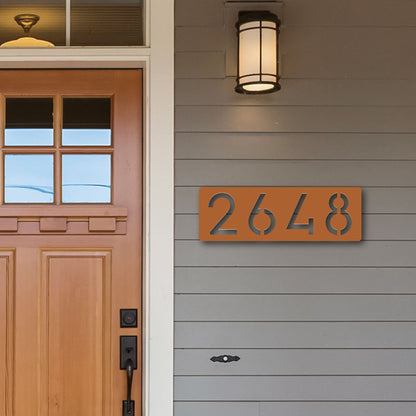 Horizontal Number Address Sign, Closed Style in copper shown next to cedar wood door on grey siding