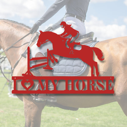 Red metal sign with horse and rider silhouette and 'I love my horse' text, mounted on a horse.
