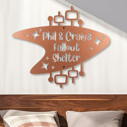 Bedroom with wooden headboard, colorful bedding, and 'Phil & Craig's Fallout Shelter' wall art.