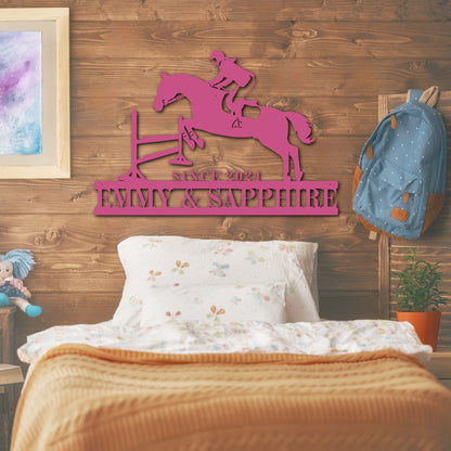 Bedroom with pink metal wall art of a horse and rider, framed picture, and backpack.