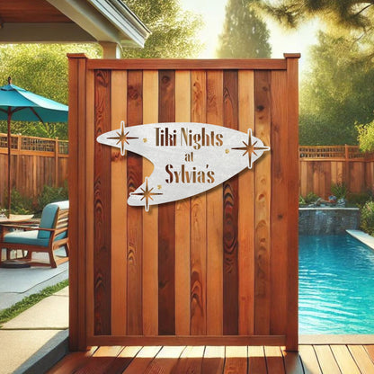Wooden privacy screen with 'Tiki Nights at Sylvia's' sign in a backyard setting.