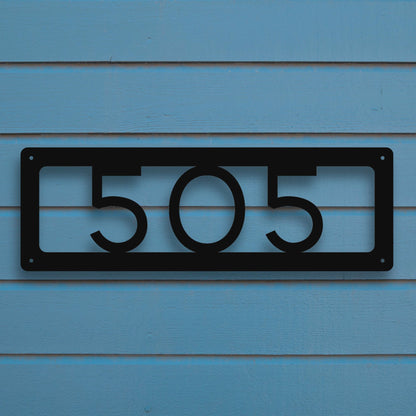 Horizontal Number Address Sign, Open Styles shown in black against blue siding of house