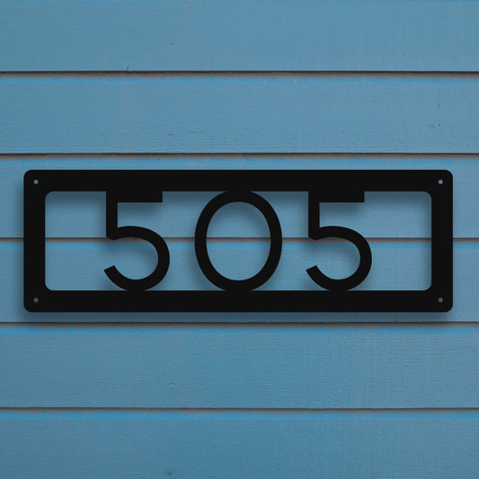 Horizontal Number Address Sign, Open Styles shown in black against blue siding of house