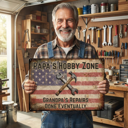 Man holding a sign in a garage with tools and equipment.