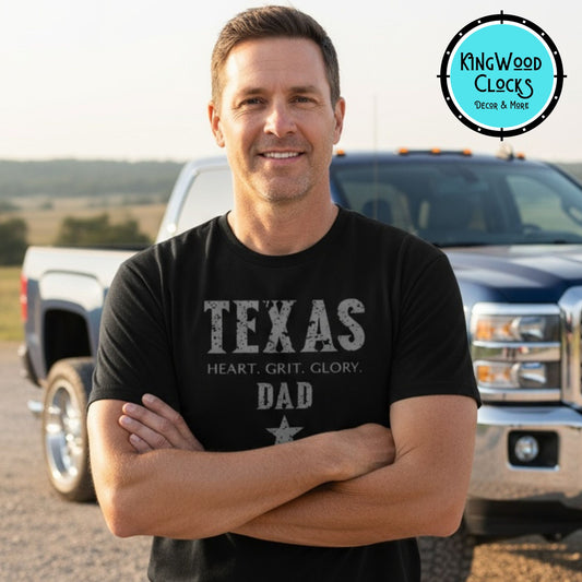Man wearing a 'Texas Dad' shirt standing in front of a truck with Kingwood Clocks logo.