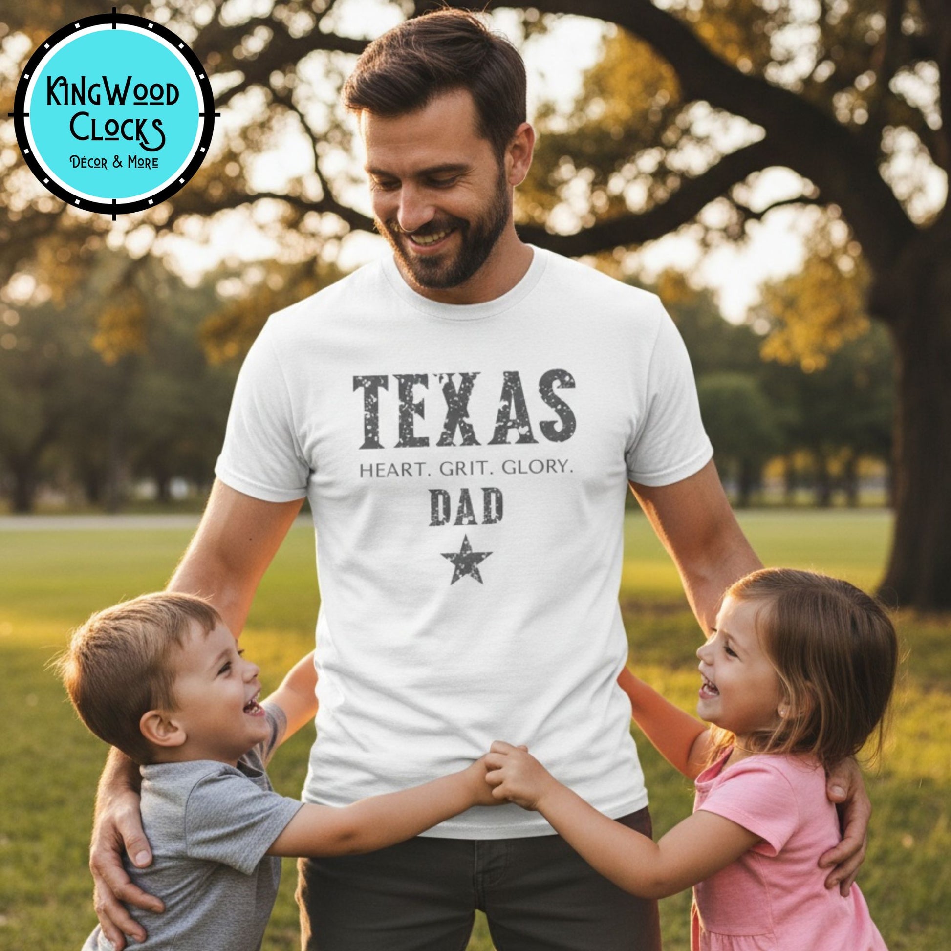 Man wearing a 'Texas Dad' t-shirt with two children in a park.
