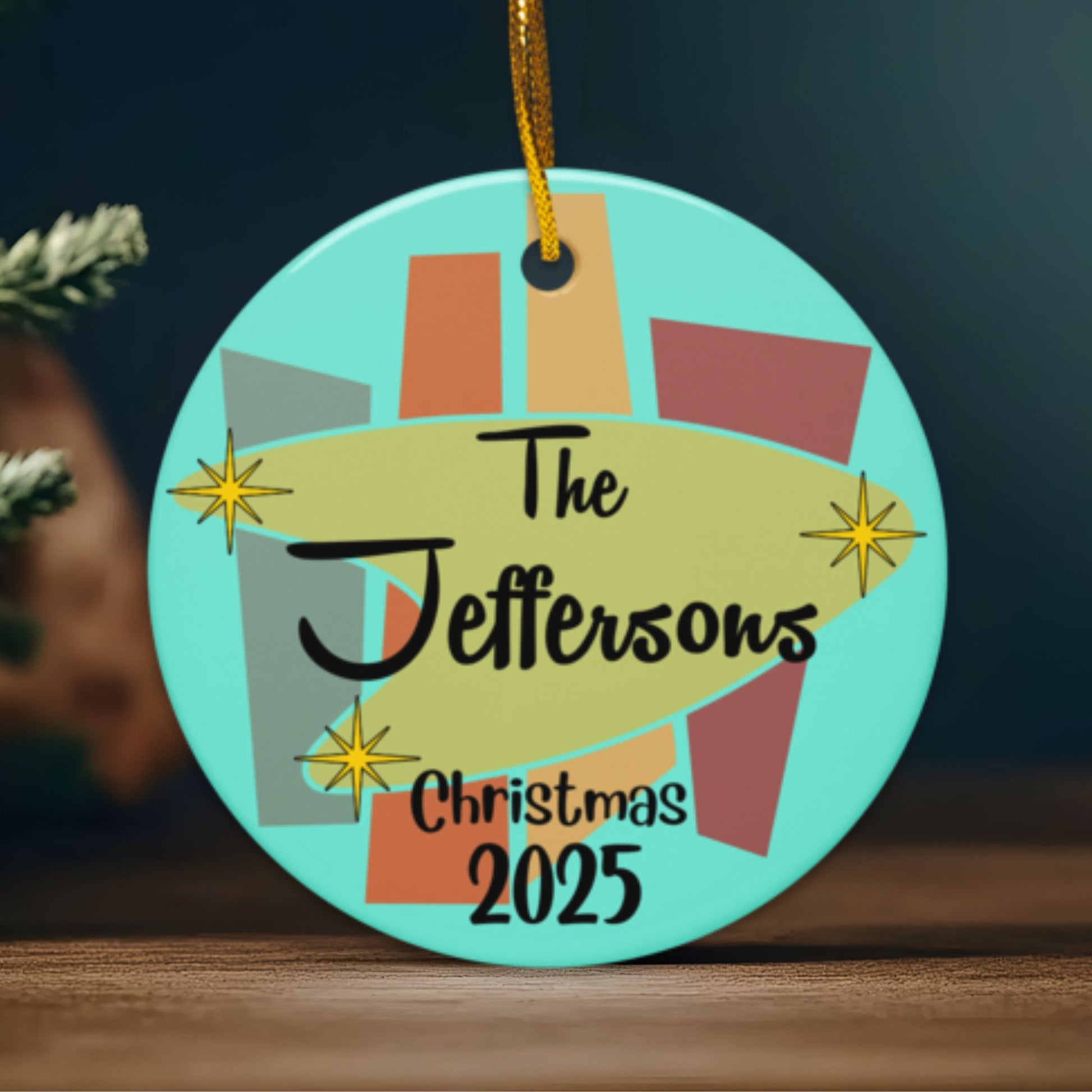 Decorative Christmas ornament with 'The Jeffersons Christmas 2025' text on a teal background.