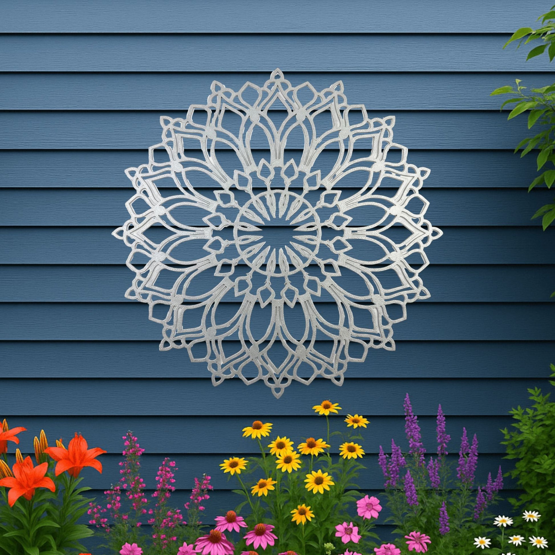 Decorative metal wall art in the shape of a flower on a blue wooden panel background with flowers at the bottom.