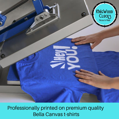 Blue t-shirt with a printed design on a screen printing machine, with 'Kingwood Clocks' logo in the corner.